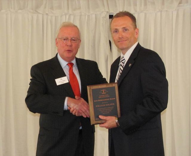 ISBA President John O'Brien presents a Law Enforcement Award to William Holman, Deputy Chief of Police of Glen Ellyn.