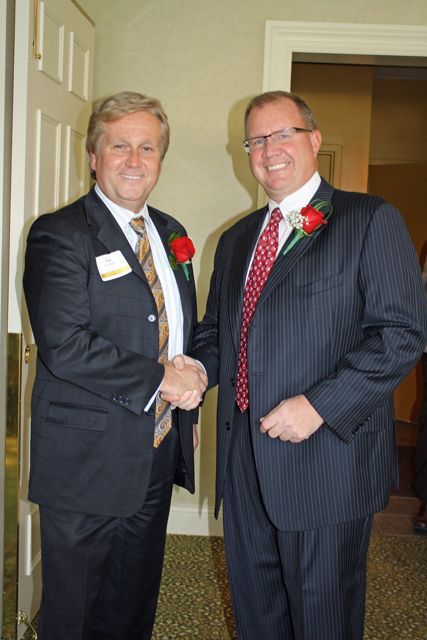 Scott Barber, outgoing president of the Northwest Suburban Bar Association (left), congratulates new President Lee F. DeWald.