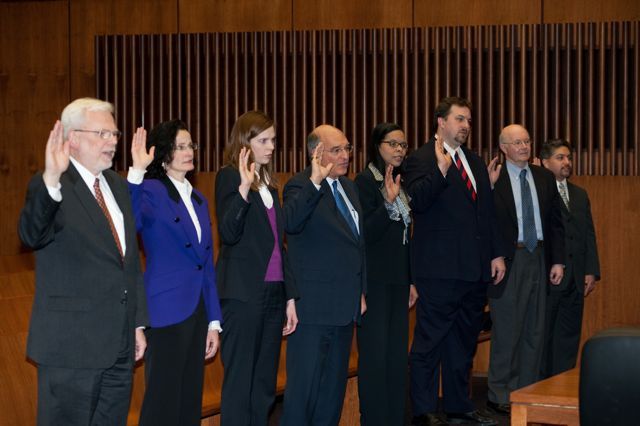 The new initiates take the oath of membership.
