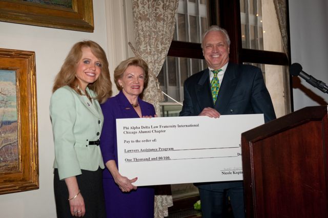 In furtherance of the fraternity's mission of service, past Chapter Justice Royal F. Berg and Michele Jochner present a check for $1,000 to Janet Piper Voss, Executive Director of the Lawyers Assistance Program, in support of LAP.