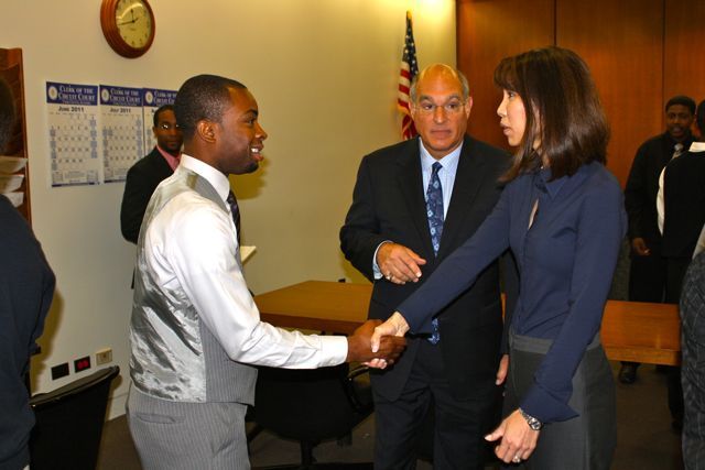 Teacher Tyrese Foreman greets Judge Liu.