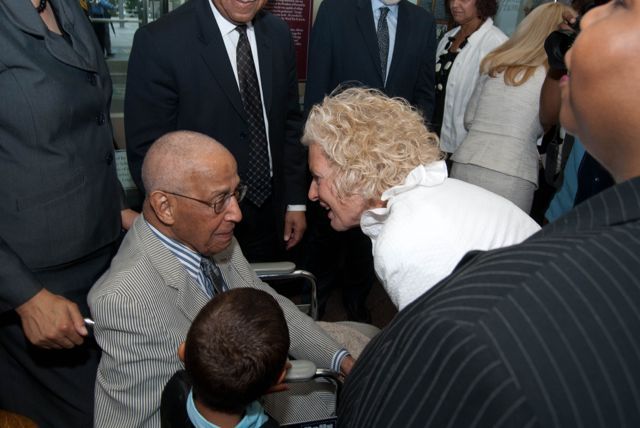 Illinois Supreme Court Justice Anne. M. Burke congratulates Judge Leighton and presents him with a copy of his oath to become a member of the Illinois bar, which he took in 1947.
