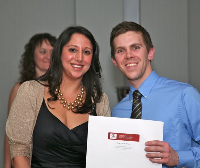 YLD Soiree Co-Chair Gina Rossi presents a raffle prize 