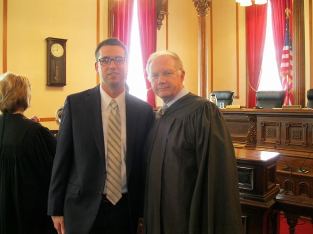 New admittee Zach Milus and Chief Justice Thomas L. Kilbride.
