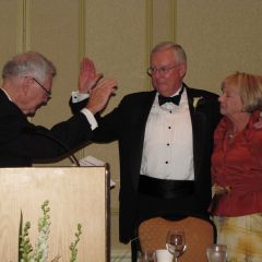 President O'Brien is sworn in by Illinois Supreme Court Chief Justice Thomas Fitzgerald as Karen O'Brien looks on.