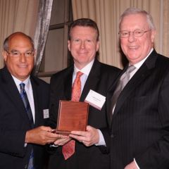 Deputy ARDC Administrator James J. Grogan receives a medal on behalf of Rosalyn B. Kaplan