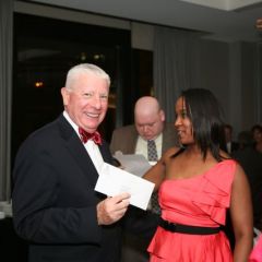 Kenya Jenkins-Wright presents David Sosin with White Sox tickets he won in the raffle.