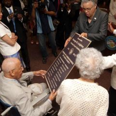 Cook County Board President Toni Preckwinkle and Judge William Hooks present a copy of a permanent building plaque to Judge Leighton.  Judge Leighton's daughter, Barbara Whitfield, and his sister, look on.