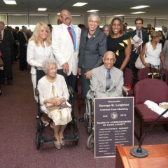 Cook County Board President Toni Preckwinkle (third from right) and event Steering Committee Co-Chairs Michele Jochner, Hon. William Hooks and Juliana Stratton, congratulate Judge Leighton and his sister. 