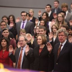 The new members take the initiation oath.