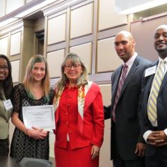 Event co-chairs Kenya Jenkins-Wright (left) and David Kadzai (right) with ISBA President-elect Paula H. Holderman, a student accepting the 2nd place prize on behalf of Iryna Motyashok of Skinner High School and CCBA President John A. Fairman. 