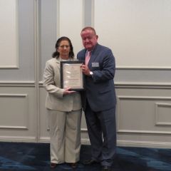 Lynn Patton, Austin Fleming Newsletter Editor Award recipient,&nbsp;and President Russell Hartigan
